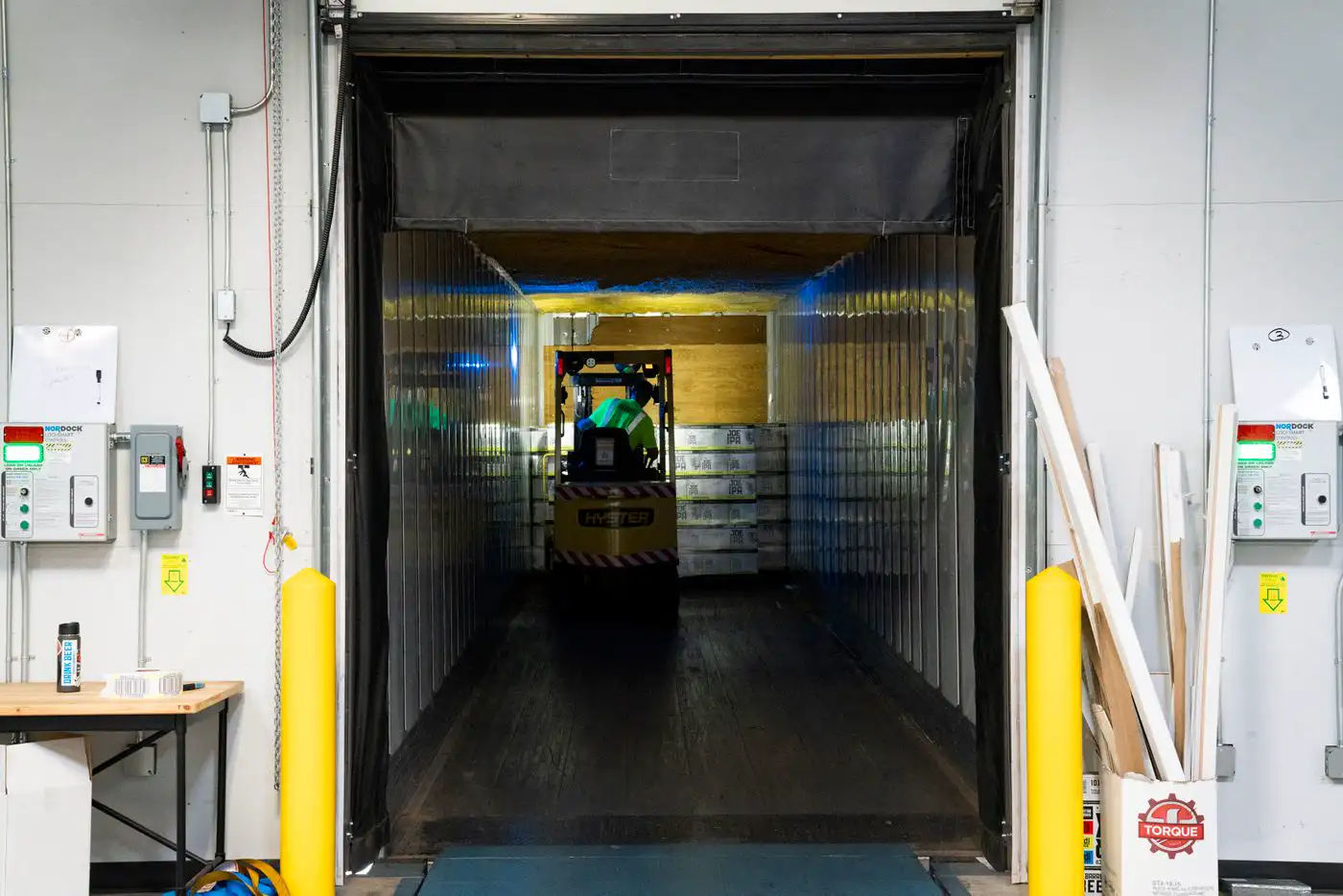A forklift working inside a temperature-controlled loading dock