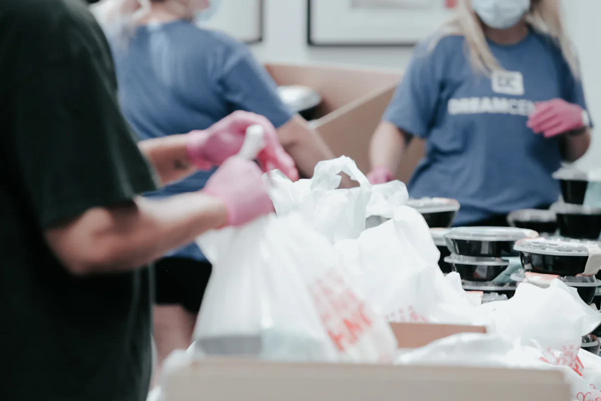 Volunteers packing food into boxes